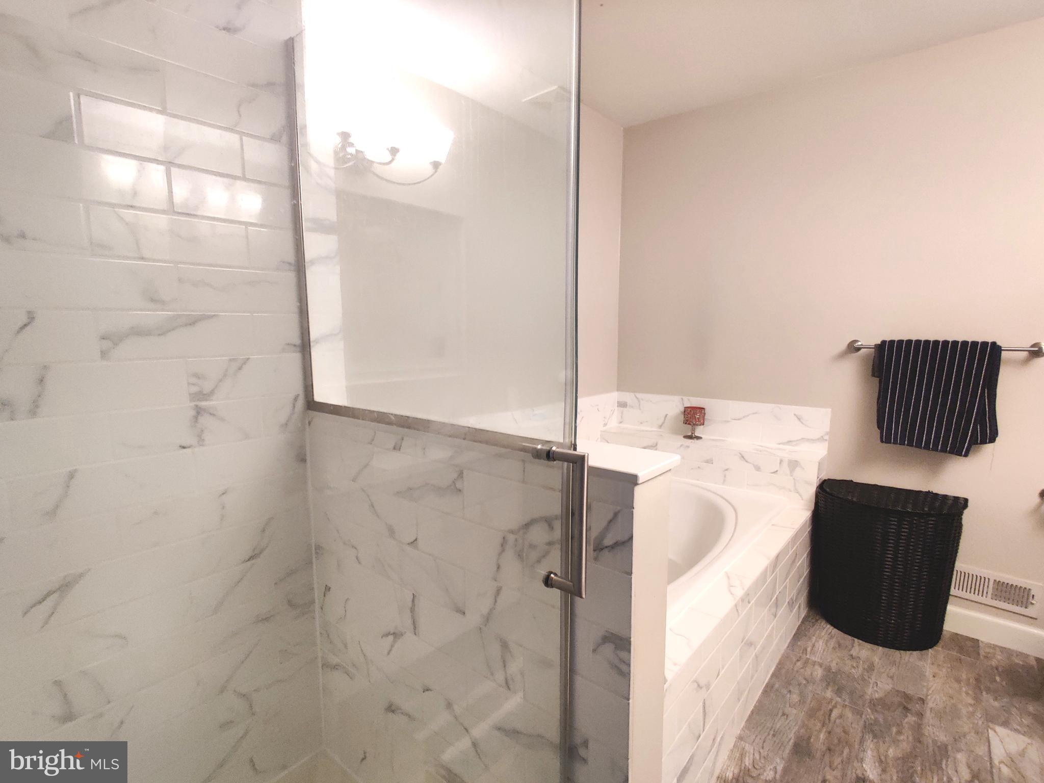 23 Stokes Road Mount Laurel, NJ 08054 - Photo 10 of 18 a bathroom with a bathtub and shower