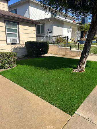 a view of house with backyard and garden