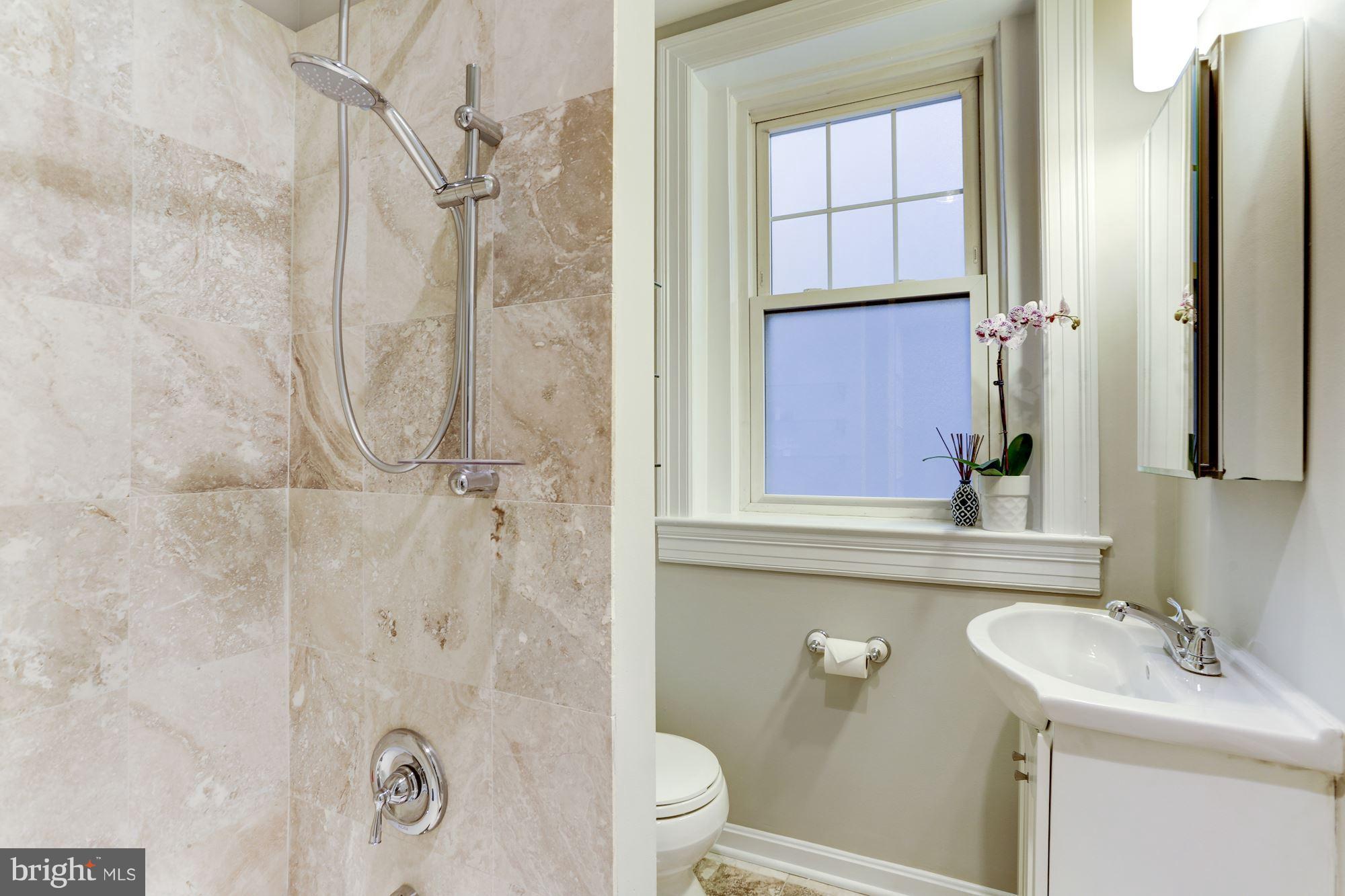 1322 15th Street Northwest, Unit 32 Washington, DC 20005 - Photo 10 of 20 renovated Travertine tile bathroom