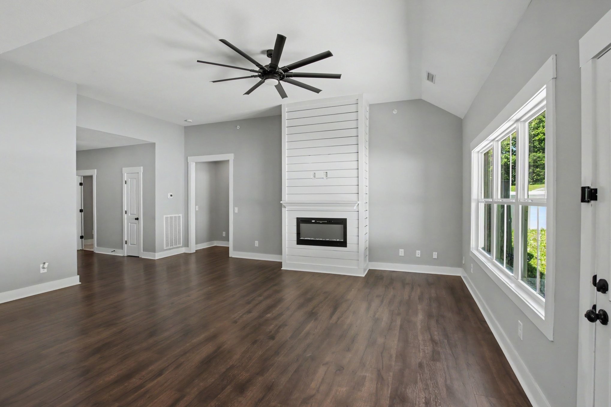 7208 Winding Way Pleasant View, TN 37146 - Photo 4 of 30 an empty room with wooden floor fan and windows