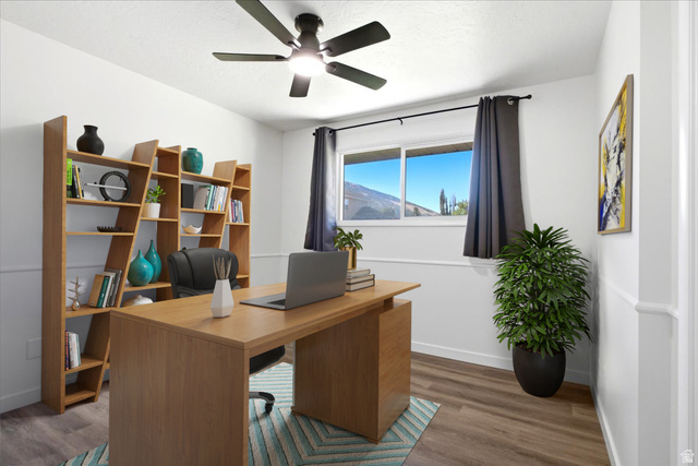 1676 East 11245 South Sandy, UT 84092 - Photo 15 of 34 Room featuring wood-finish flooring, a contemporary ceiling fan, and white wall paneling. This photo is virtually staged.