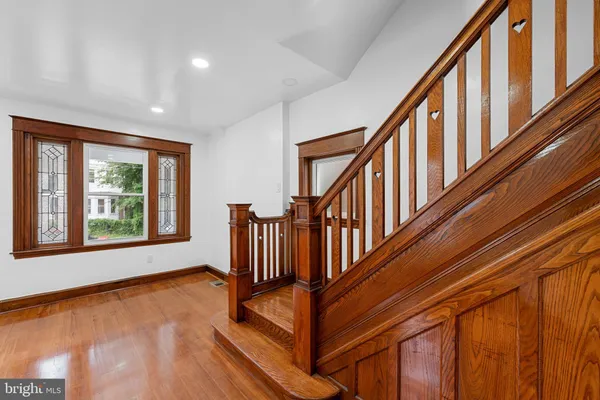 a view of an entryway with wooden floor and door