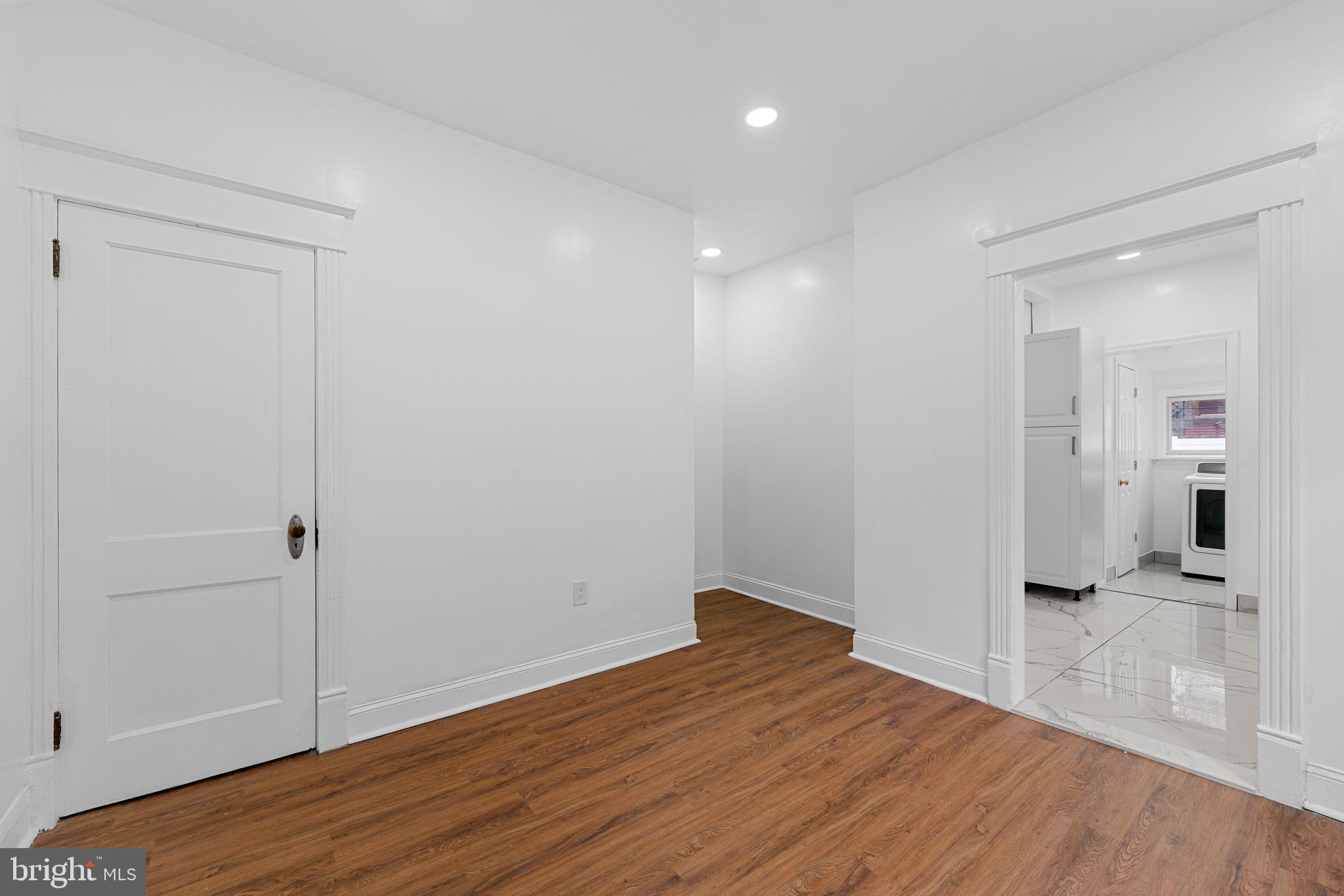 407 Sanger Street Philadelphia, PA 19120 - Photo 18 of 47 a view of a hallway with wooden floor and a bathroom