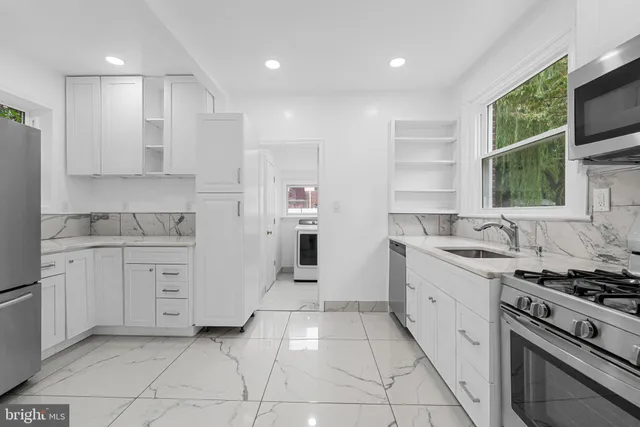 a kitchen with granite countertop cabinets and steel stainless steel appliances