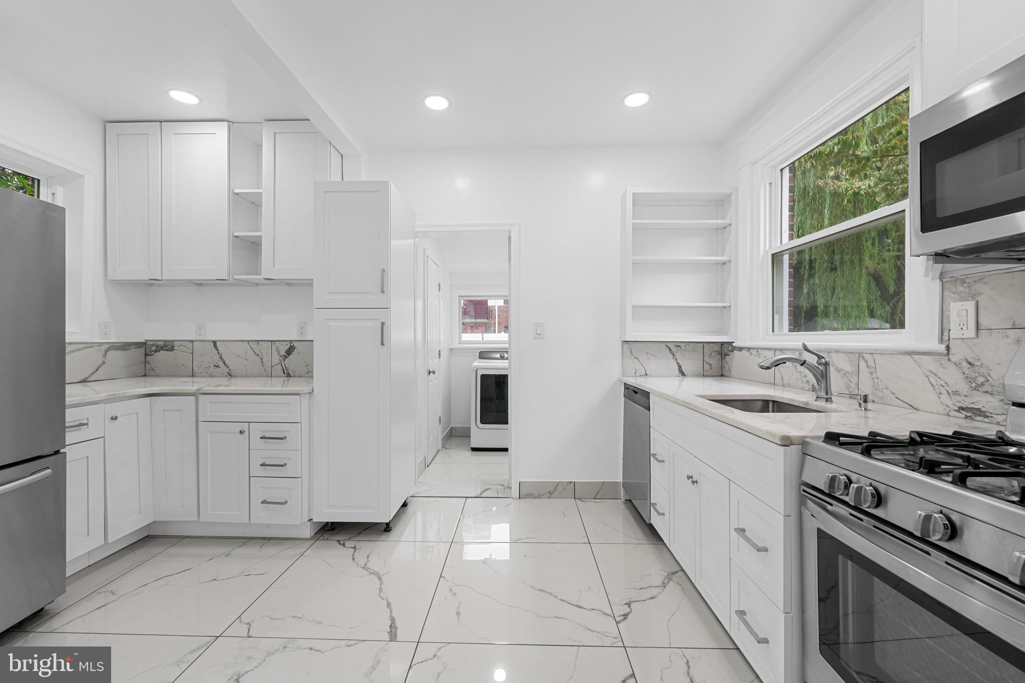 407 Sanger Street Philadelphia, PA 19120 - Photo 20 of 47 a kitchen with granite countertop cabinets and steel stainless steel appliances