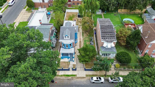an aerial view of a houses with yard