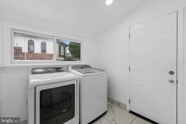 a view of washer and dryer with kitchen in the background