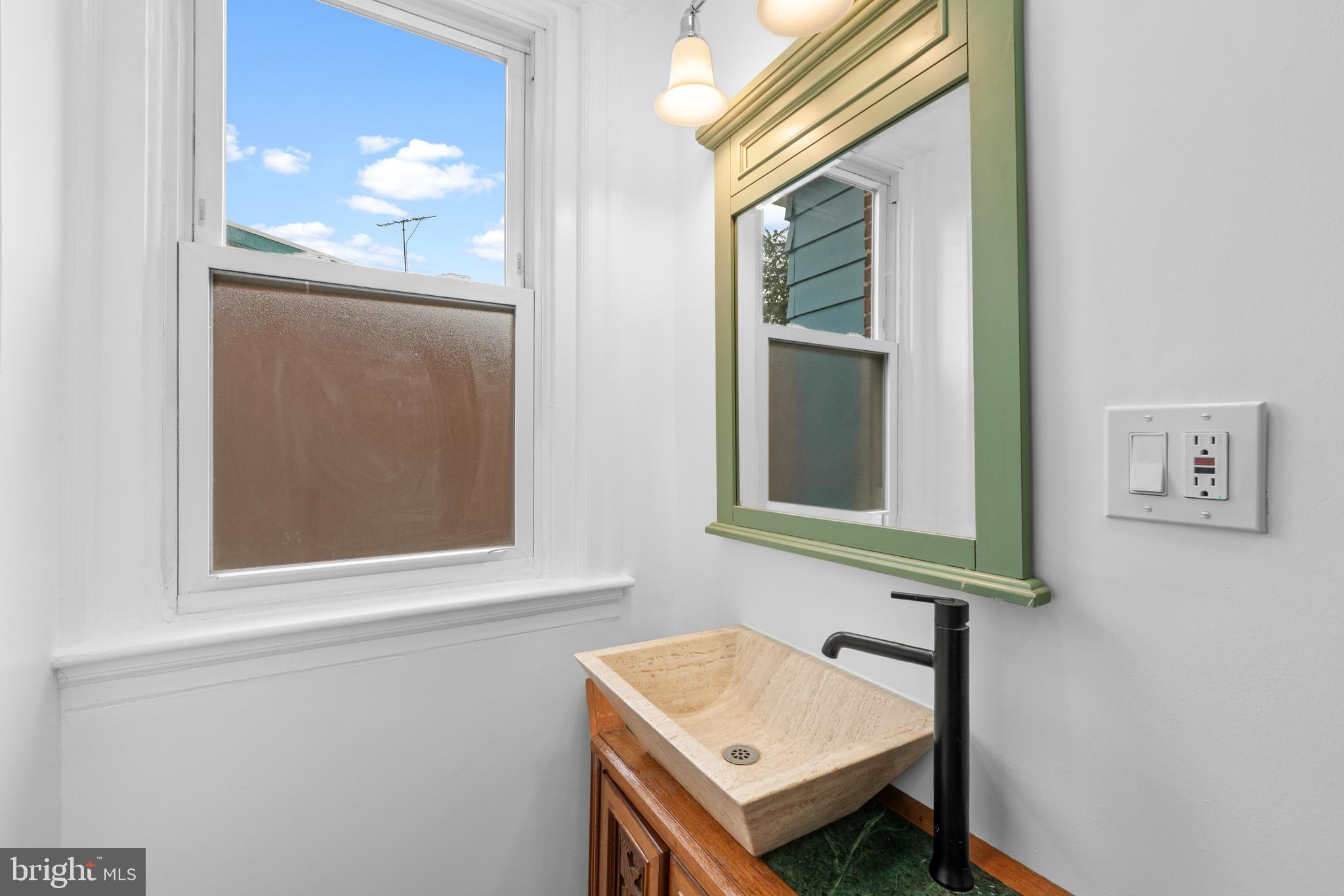 407 Sanger Street Philadelphia, PA 19120 - Photo 45 of 47 a bathroom with a sink and a mirror