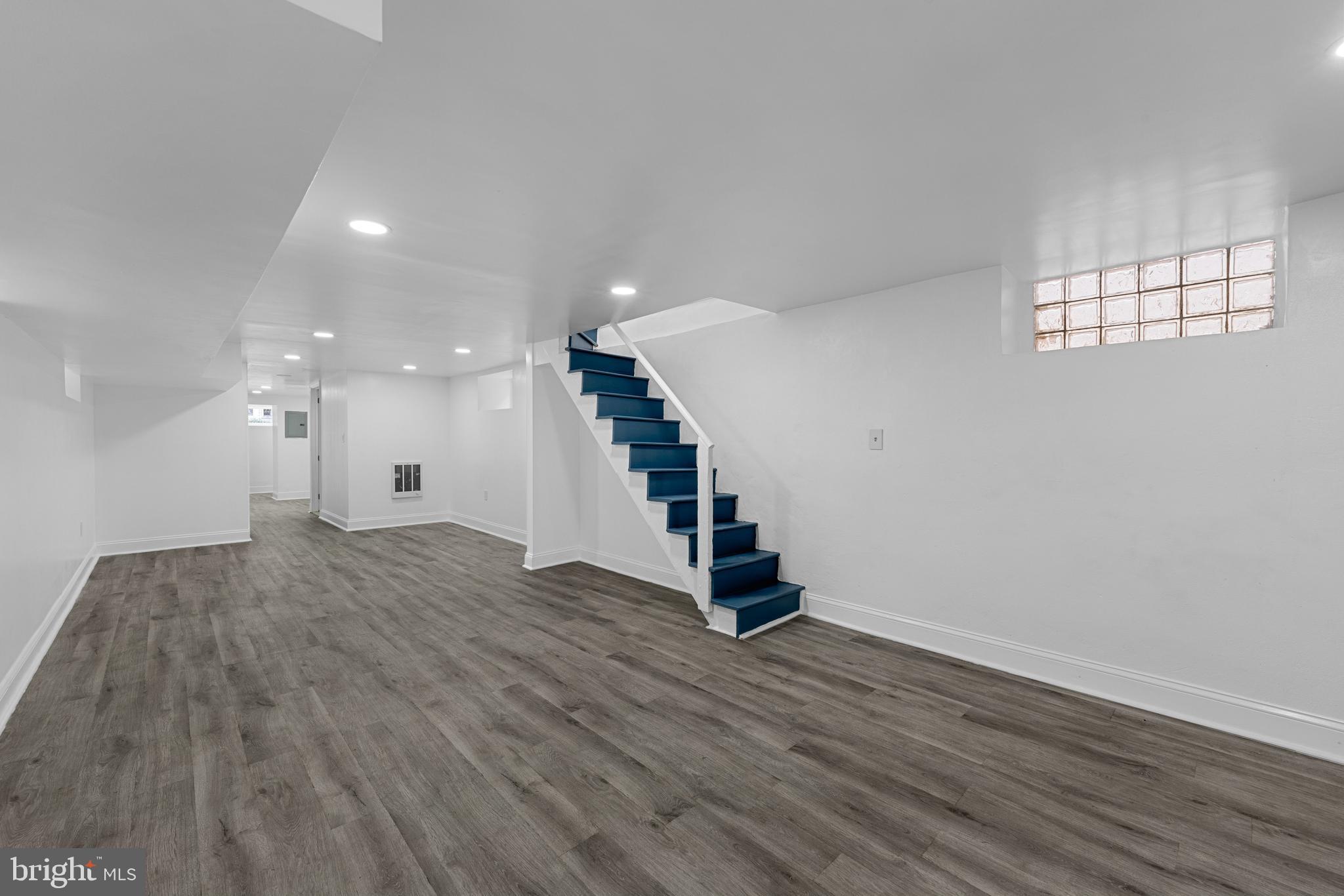 407 Sanger Street Philadelphia, PA 19120 - Photo 6 of 47 a view of an empty room with wooden floor and staircase