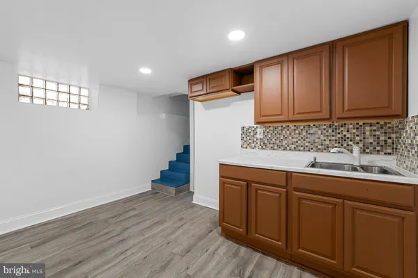 a kitchen with wooden cabinets and sink