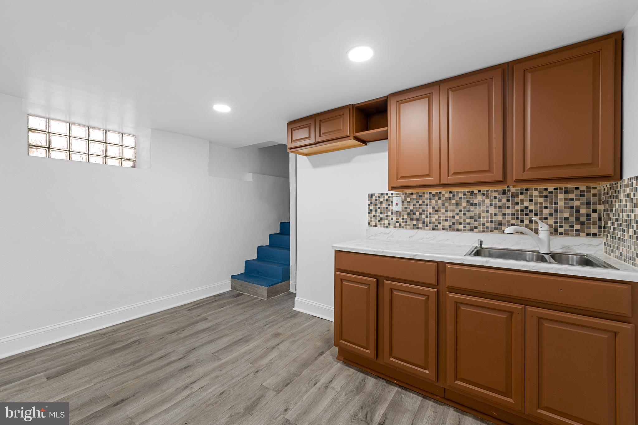 407 Sanger Street Philadelphia, PA 19120 - Photo 7 of 47 a kitchen with wooden cabinets and sink