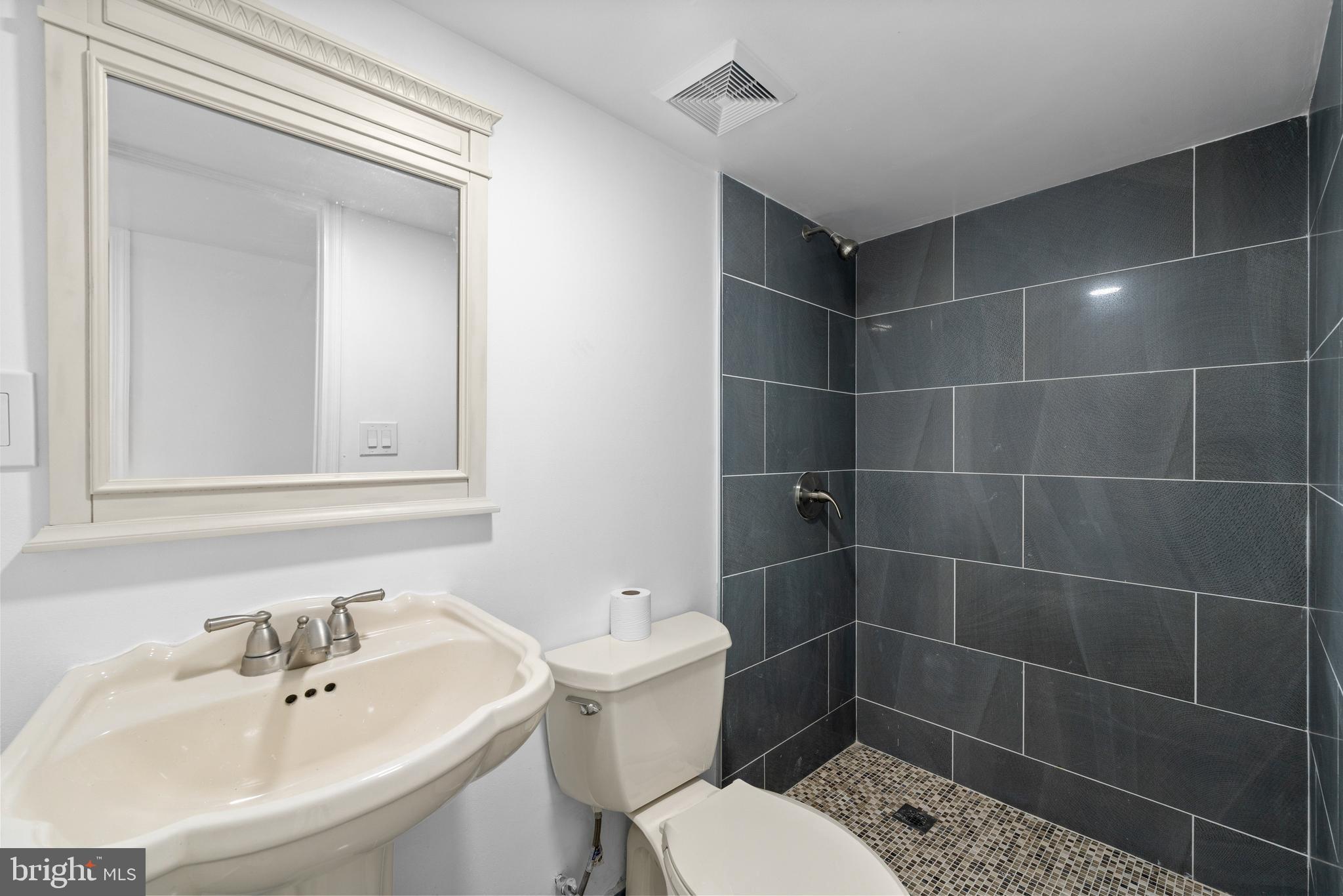 407 Sanger Street Philadelphia, PA 19120 - Photo 9 of 47 a bathroom with a sink toilet and shower