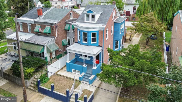 an aerial view of a residential apartment building with a yard