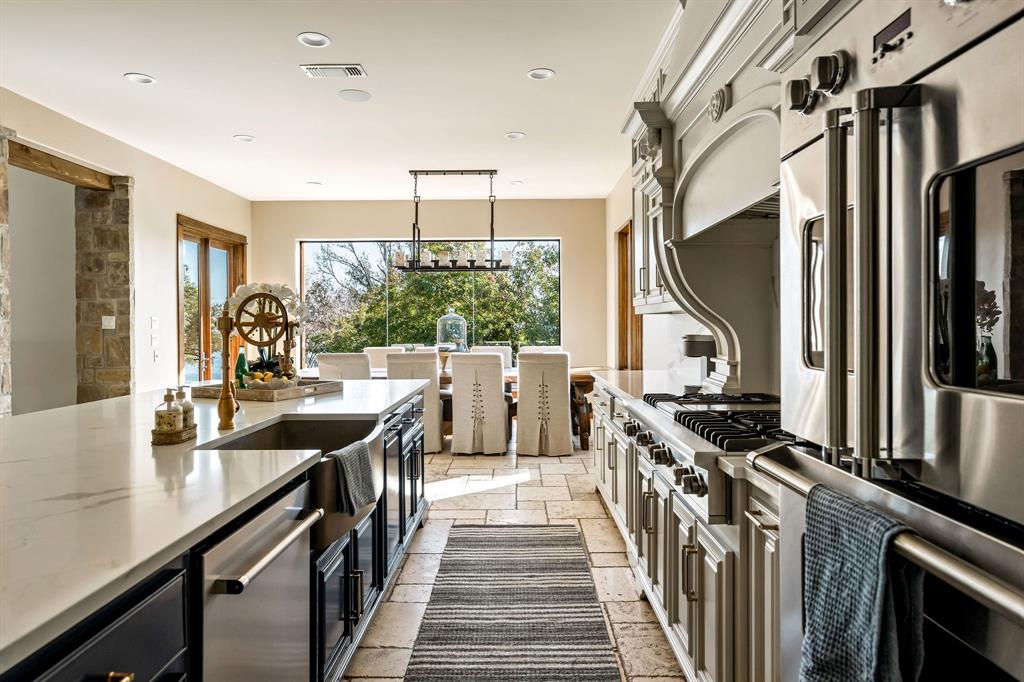9930 Boat Club Road Fort Worth, TX 76179 - Photo 16 of 40 The main house kitchen offers elegant finishes, a large island, and premium appliances designed for both style and function.