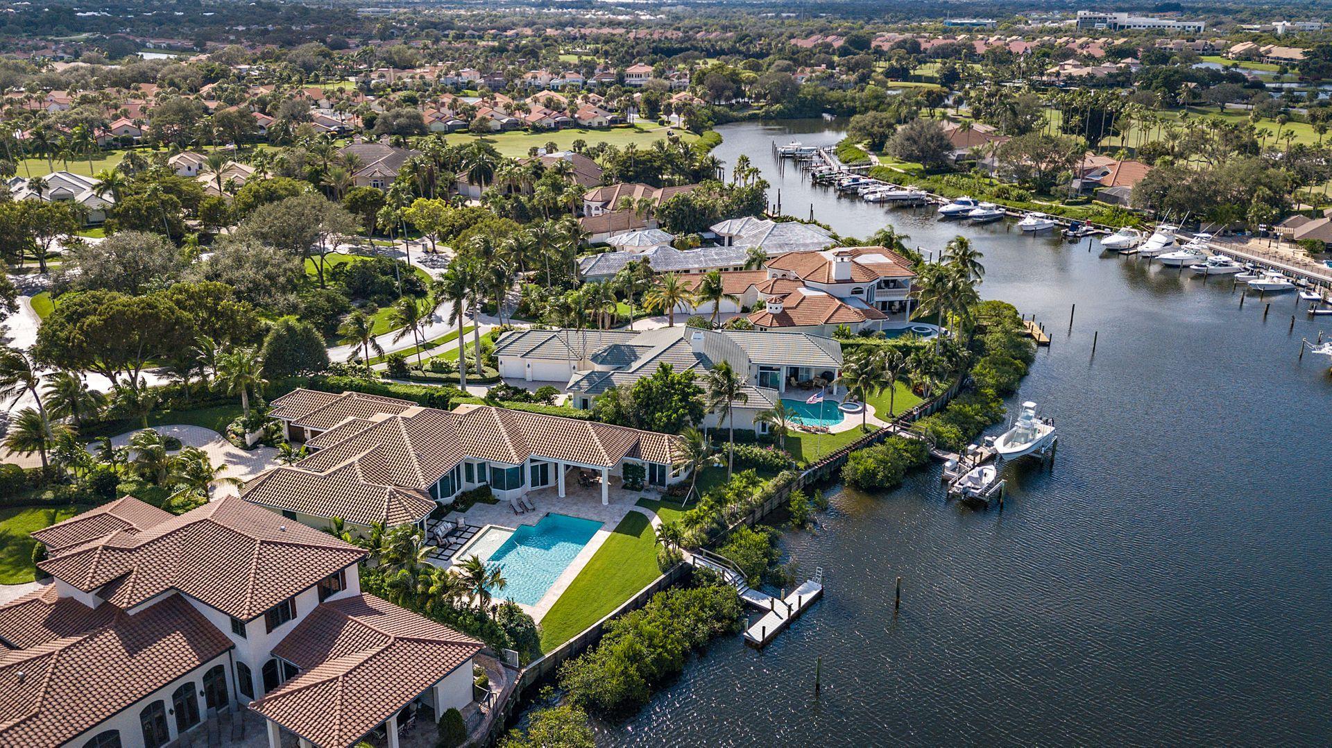3376 Barrow Island Road Jupiter, FL 33477 - Photo 2 of 48 an aerial view of a house with a yard and lake view