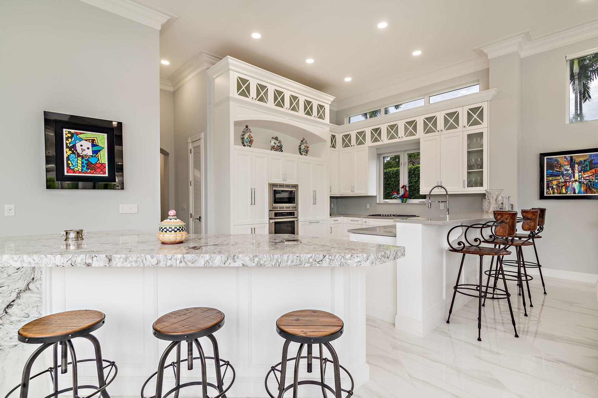 3376 Barrow Island Road Jupiter, FL 33477 - Photo 12 of 48 a kitchen with stainless steel appliances granite countertop a table and chairs in it