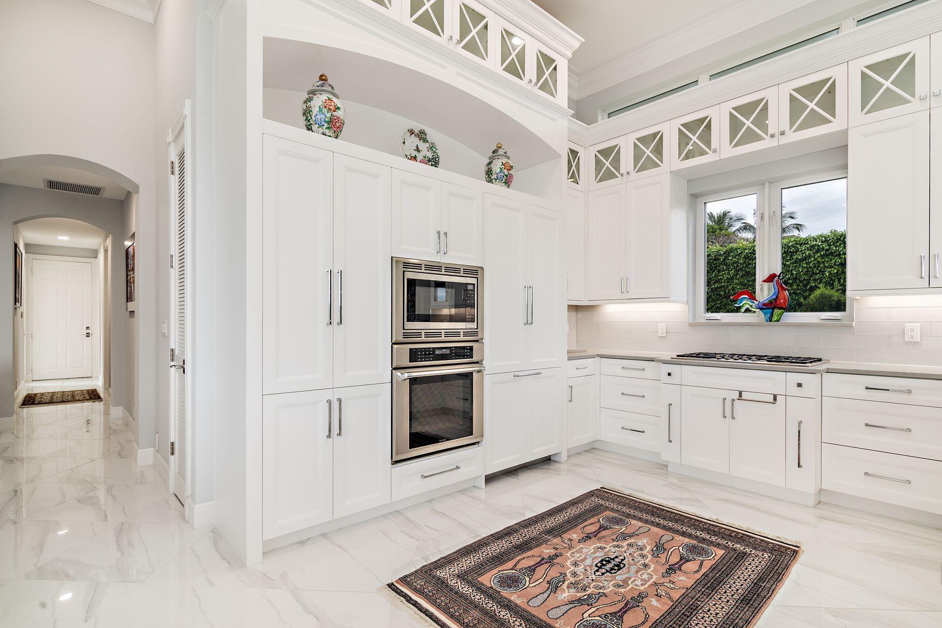 3376 Barrow Island Road Jupiter, FL 33477 - Photo 13 of 48 a kitchen with stainless steel appliances granite countertop a stove and a sink
