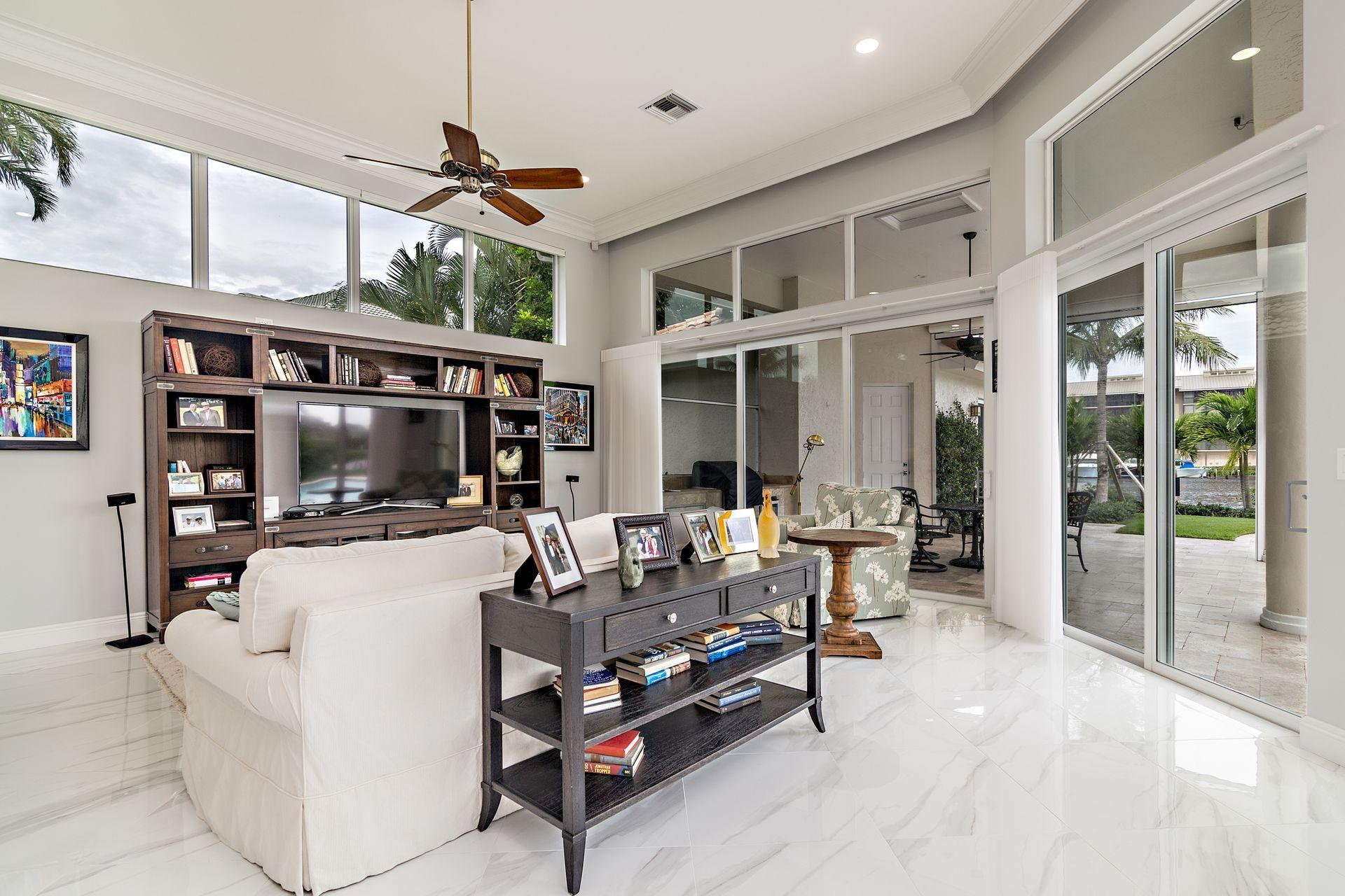 3376 Barrow Island Road Jupiter, FL 33477 - Photo 17 of 48 a living room with furniture a flat screen tv and a large window