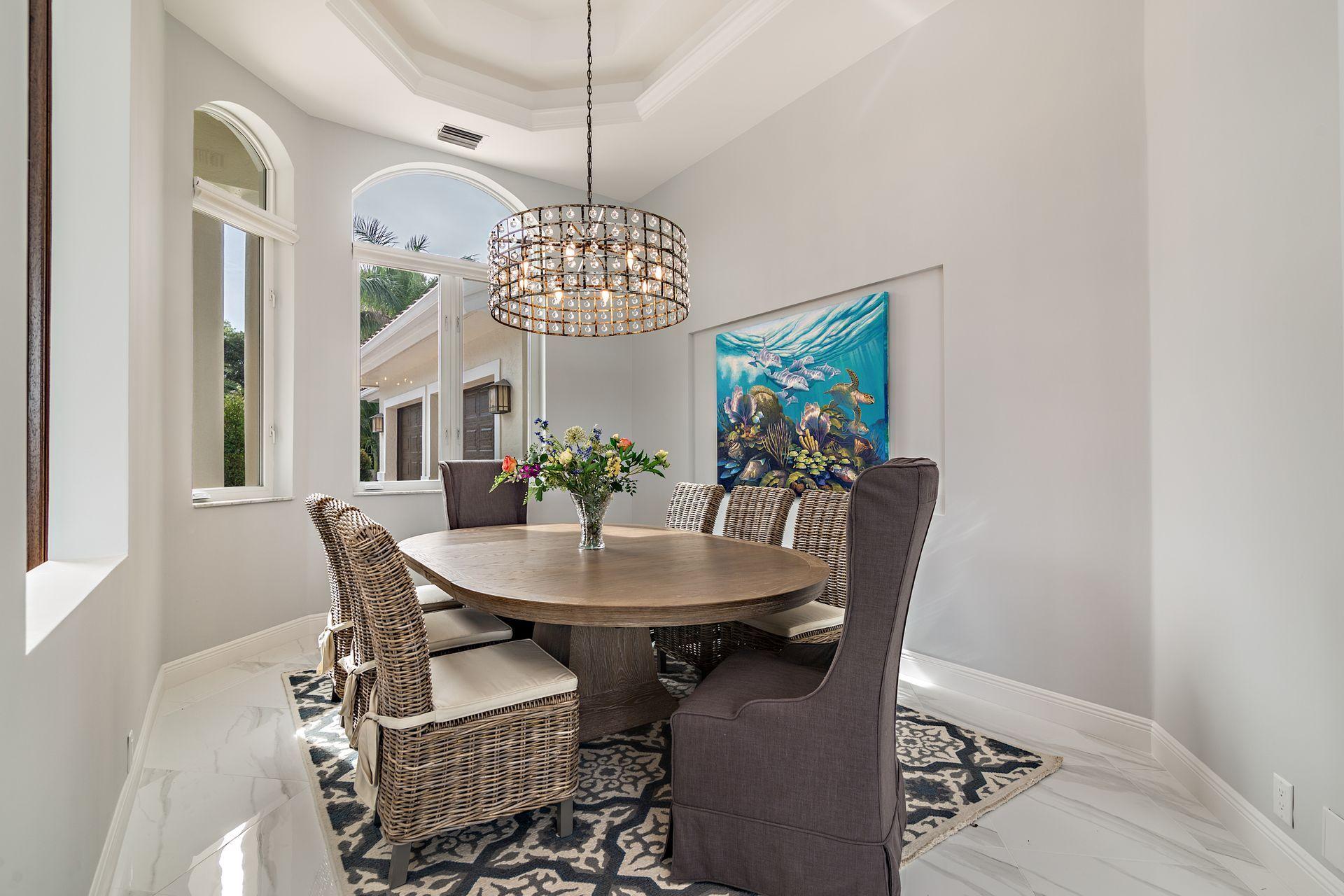 3376 Barrow Island Road Jupiter, FL 33477 - Photo 20 of 48 a view of a dining room with furniture a chandelier and wooden floor