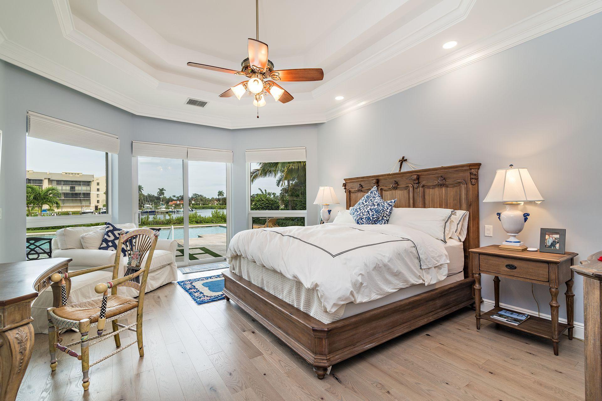 3376 Barrow Island Road Jupiter, FL 33477 - Photo 22 of 48 a bedroom with a bed and large windows