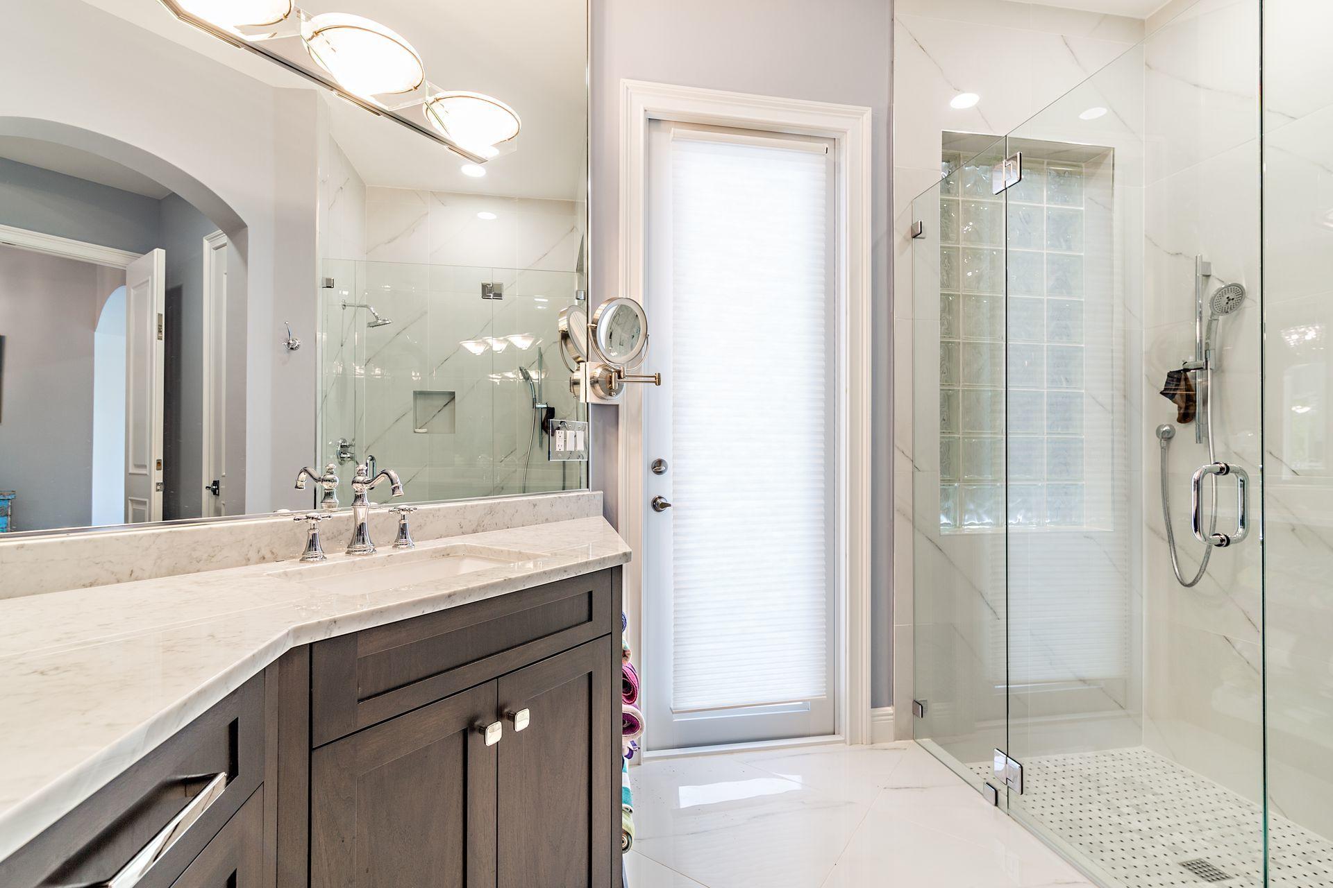 3376 Barrow Island Road Jupiter, FL 33477 - Photo 23 of 48 a bathroom with a shower sink and mirror