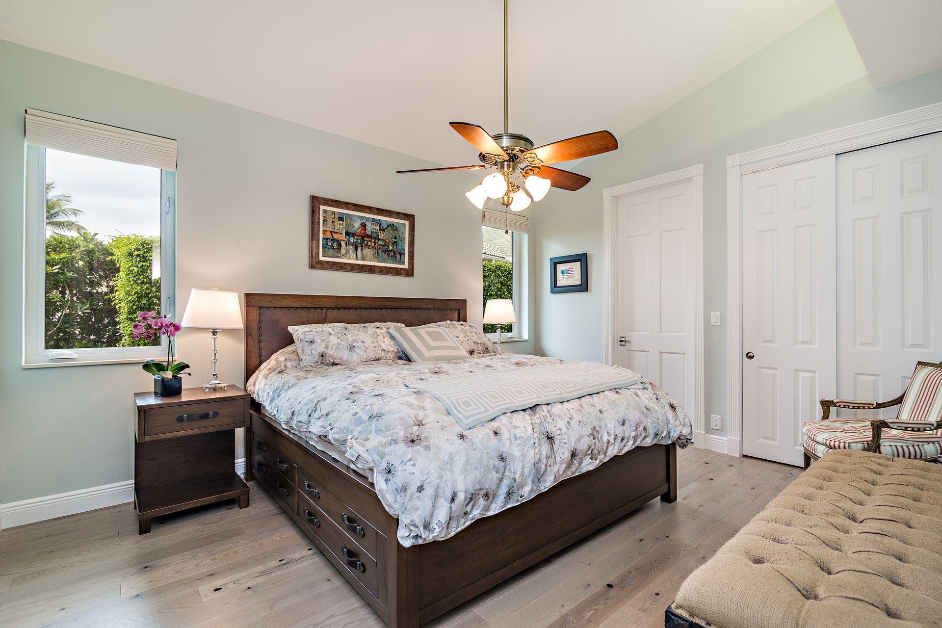 3376 Barrow Island Road Jupiter, FL 33477 - Photo 25 of 48 a bedroom with a bed and a chandelier