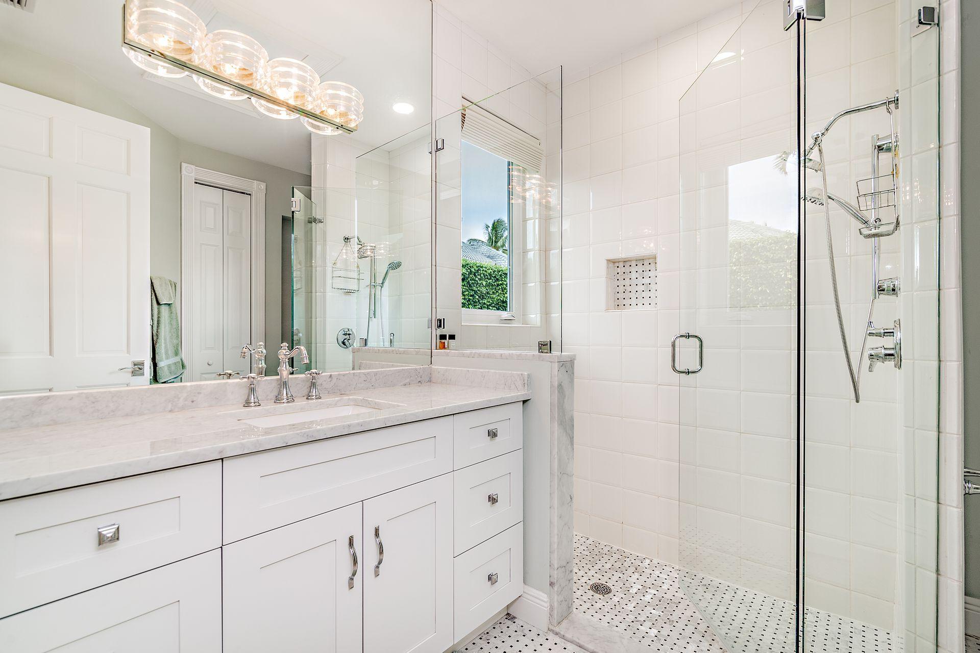 3376 Barrow Island Road Jupiter, FL 33477 - Photo 26 of 48 a bathroom with a shower sink and mirror