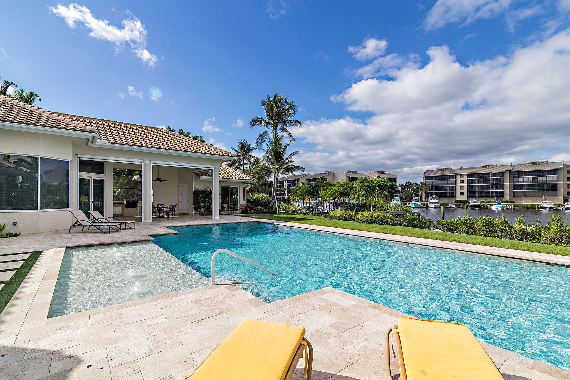 3376 Barrow Island Road Jupiter, FL 33477 - Photo 33 of 48 a view of a house with a swimming pool and a yard