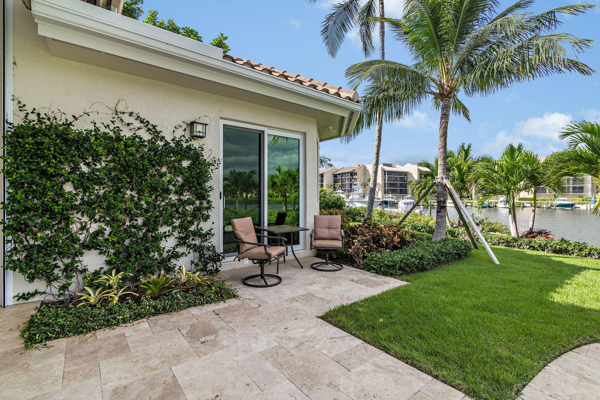 3376 Barrow Island Road Jupiter, FL 33477 - Photo 39 of 48 a view of a backyard with plants and palm tree