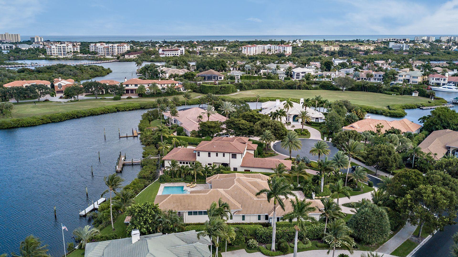 3376 Barrow Island Road Jupiter, FL 33477 - Photo 45 of 48 an aerial view of a city with lots of residential buildings lake and ocean view