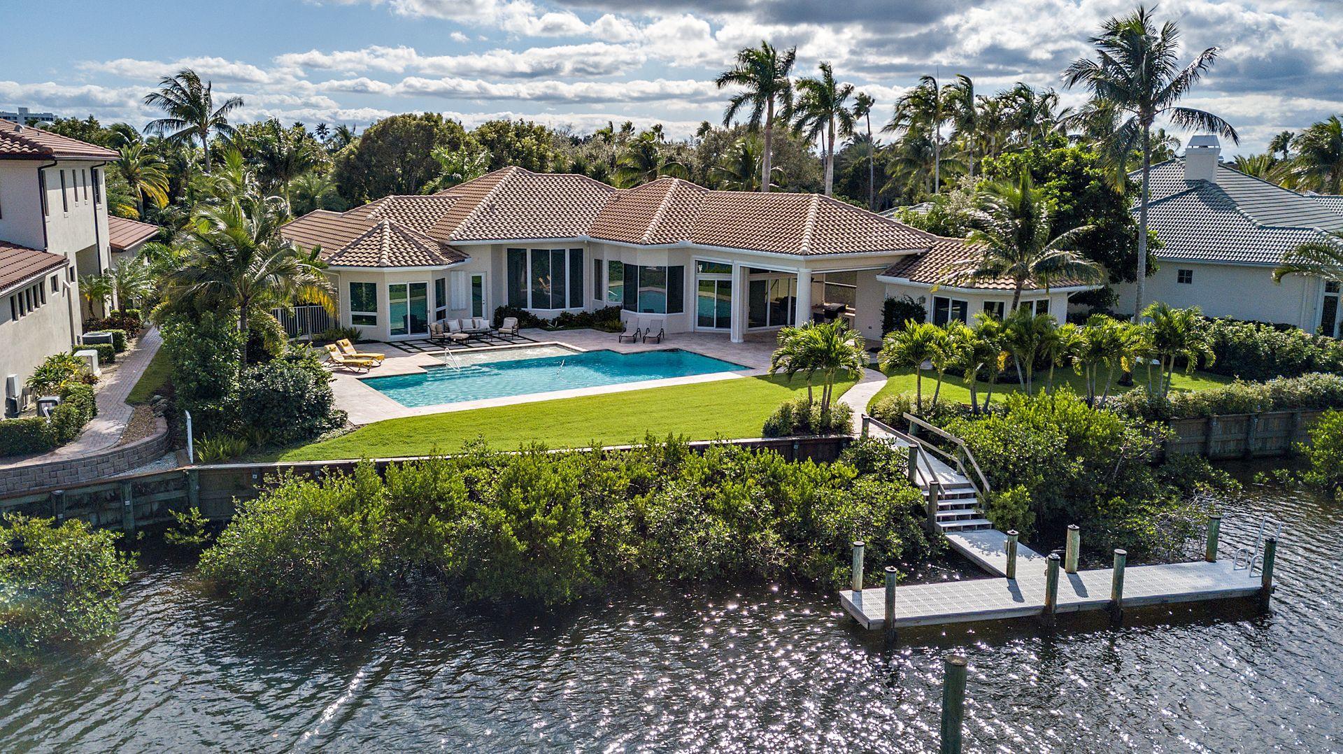 3376 Barrow Island Road Jupiter, FL 33477 - Photo 47 of 48 a front view of a house with swimming pool having outdoor seating