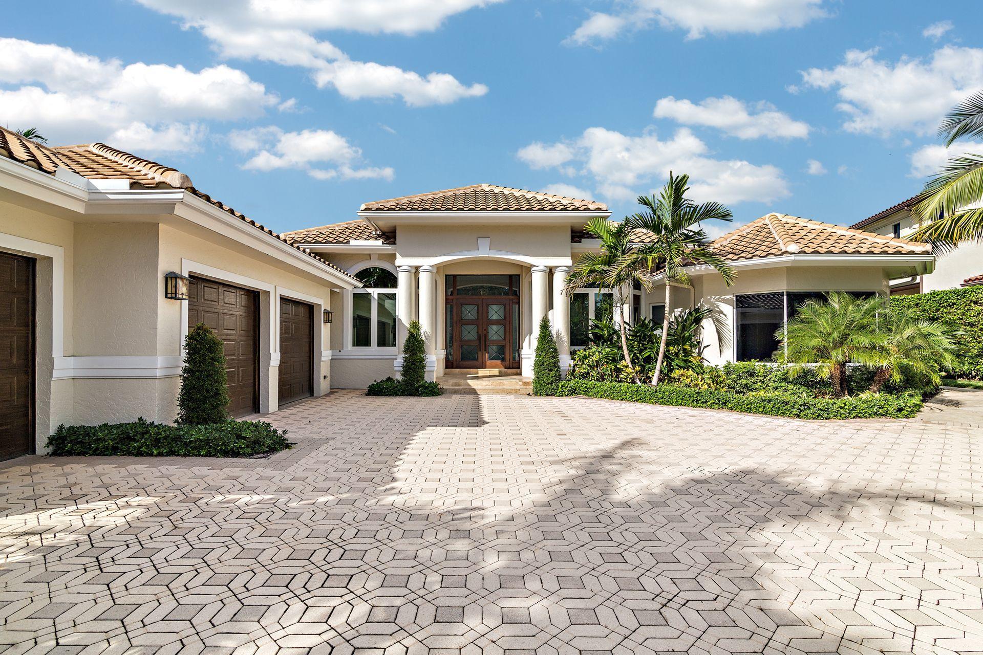 3376 Barrow Island Road Jupiter, FL 33477 - Photo 6 of 48 a view of a white house with a yard