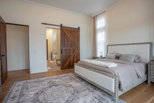 a living room with furniture wooden floor and a large window