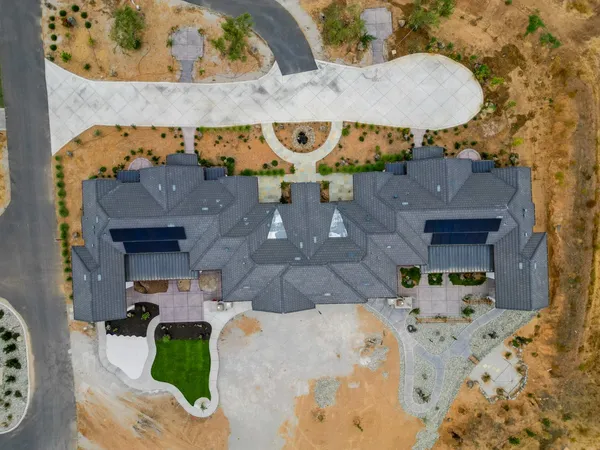 an aerial view of a house with a swimming pool