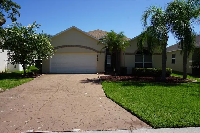 a front view of house with yard and green space