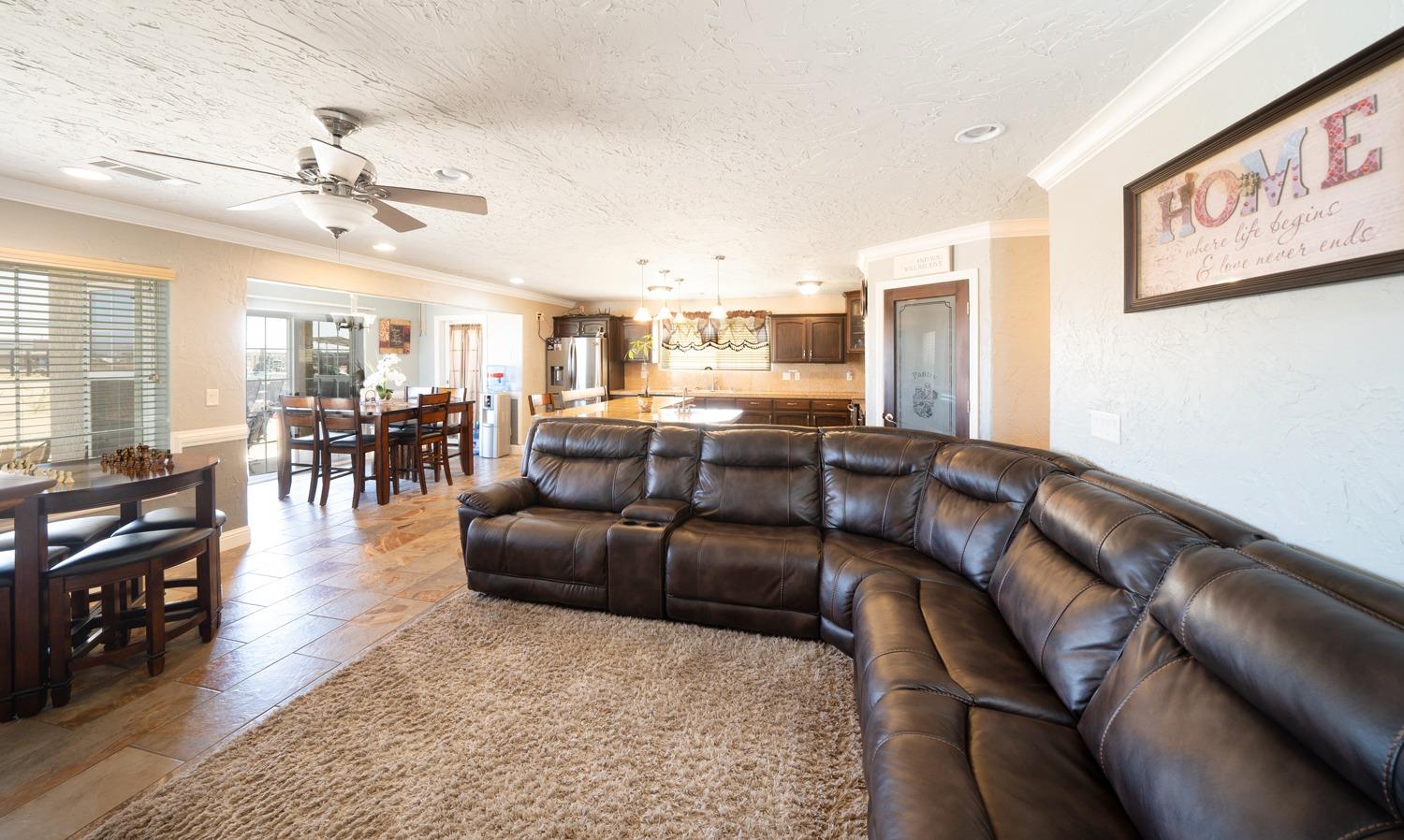 21197 Steward Road Madera, CA 93638 - Photo 14 of 41 a living room with furniture kitchen view and a dining table