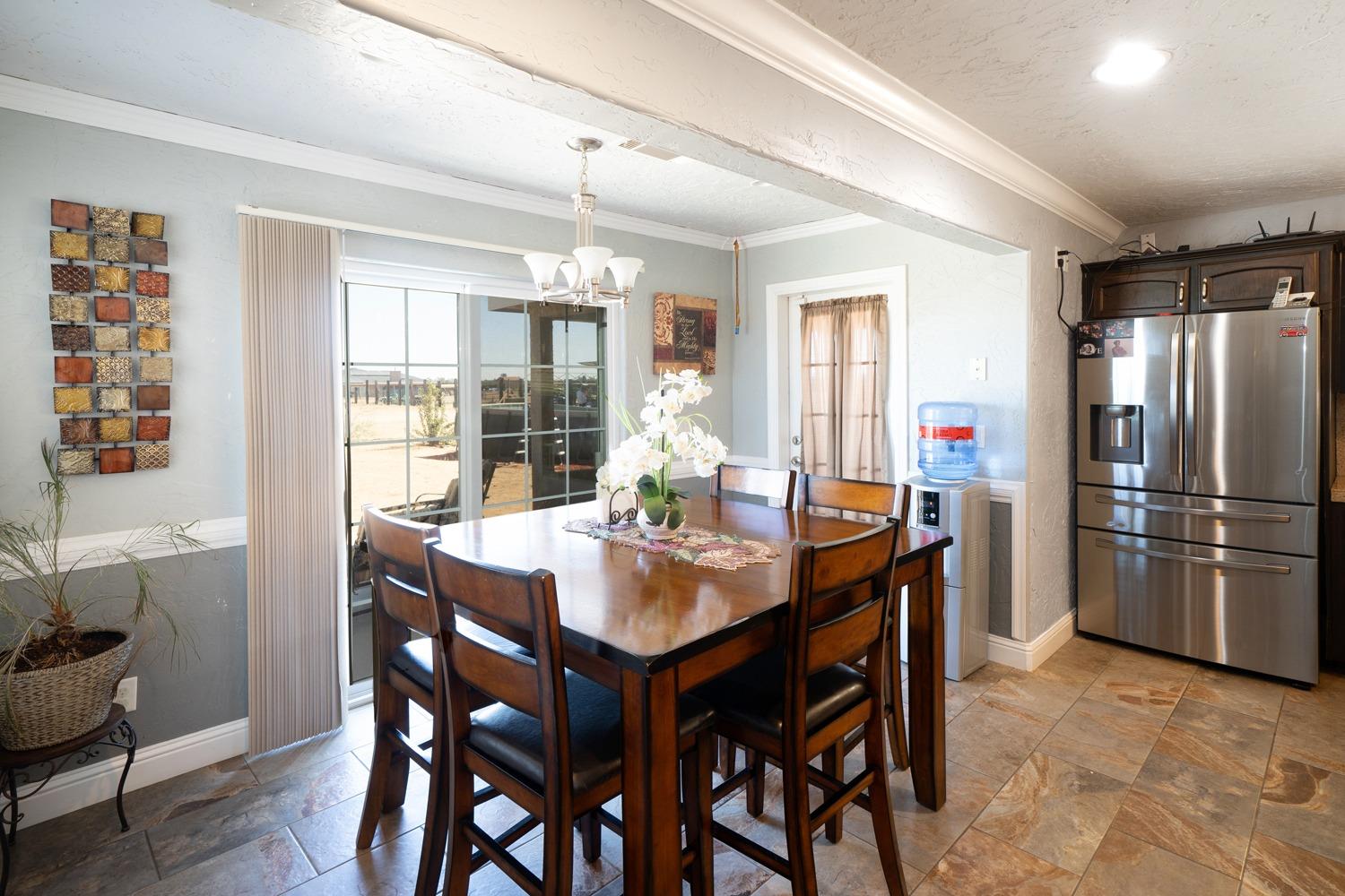 21197 Steward Road Madera, CA 93638 - Photo 16 of 41 a dining room with furniture a chandelier and window