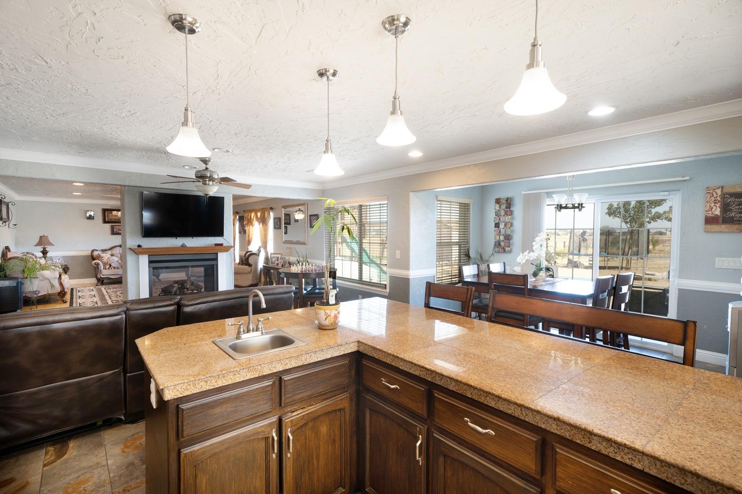 21197 Steward Road Madera, CA 93638 - Photo 17 of 41 a view of a center island and living room with furniture