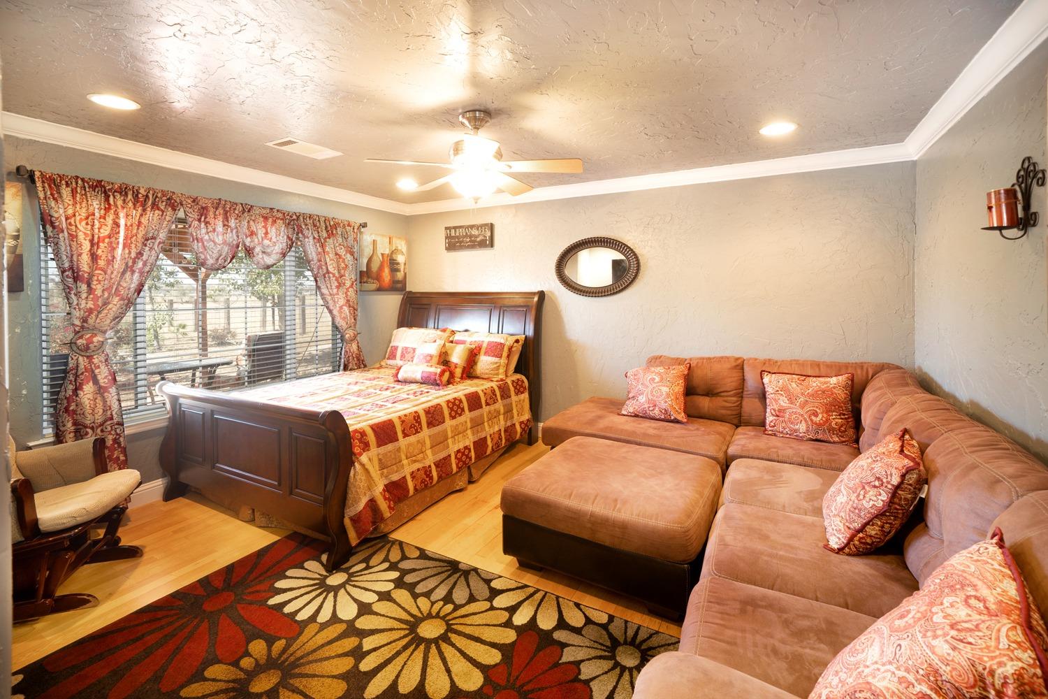 21197 Steward Road Madera, CA 93638 - Photo 21 of 41 a bedroom with furniture and a large window