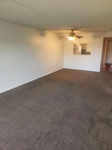 an empty room with windows and entrance