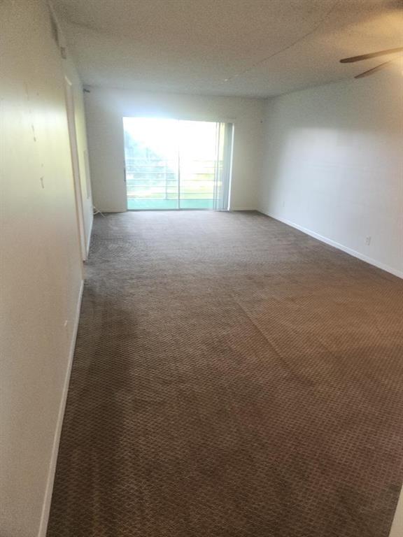 613 South State Road 7, Unit 3E Margate, FL 33068 - Photo 7 of 15 an empty room with windows and entrance