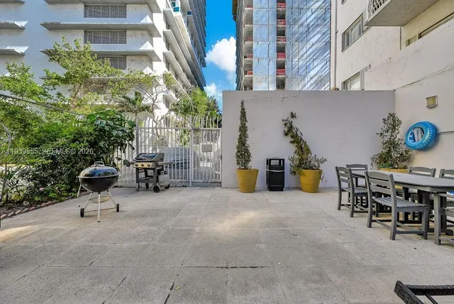 a view of a patio with table and chairs and potted plants