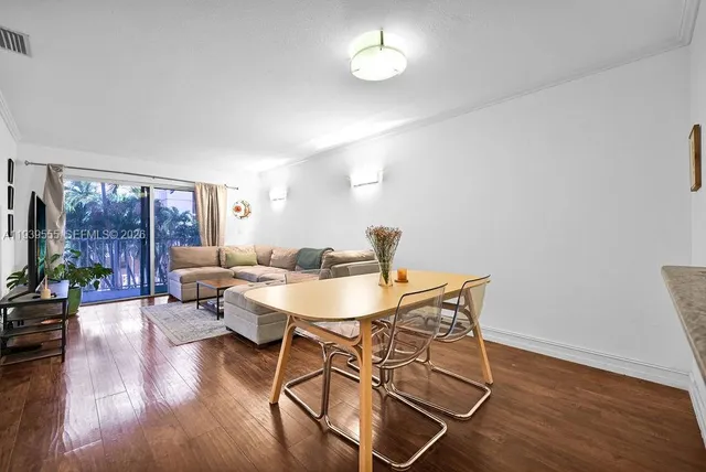 a view of a dining room with furniture and wooden floor