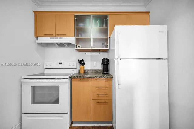 a white refrigerator freezer sitting inside of a kitchen