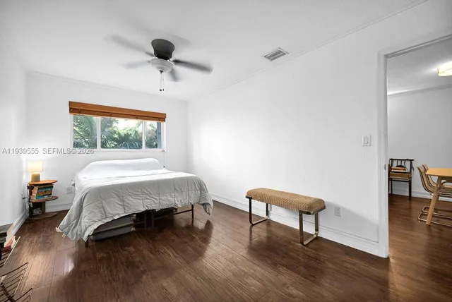 a bedroom with a bed and a chair