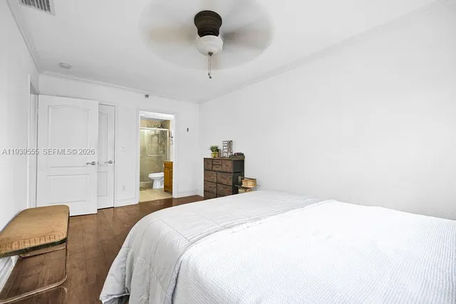 a bedroom with a bed and a chair