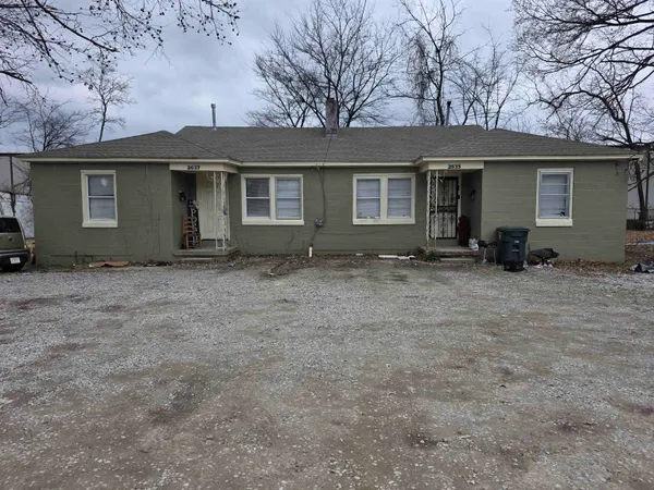 a front view of a house with trees