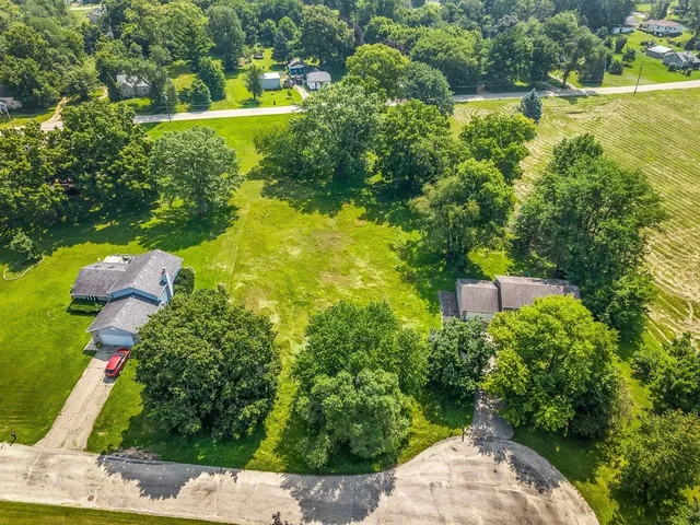 an aerial view of a house with a yard basket ball court and outdoor seating