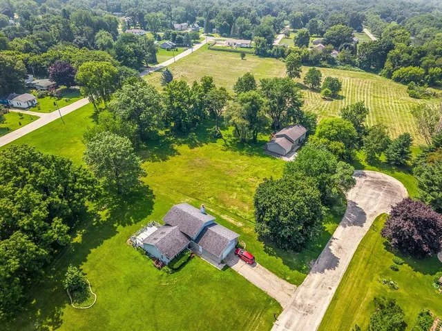 an aerial view of residential houses with yard