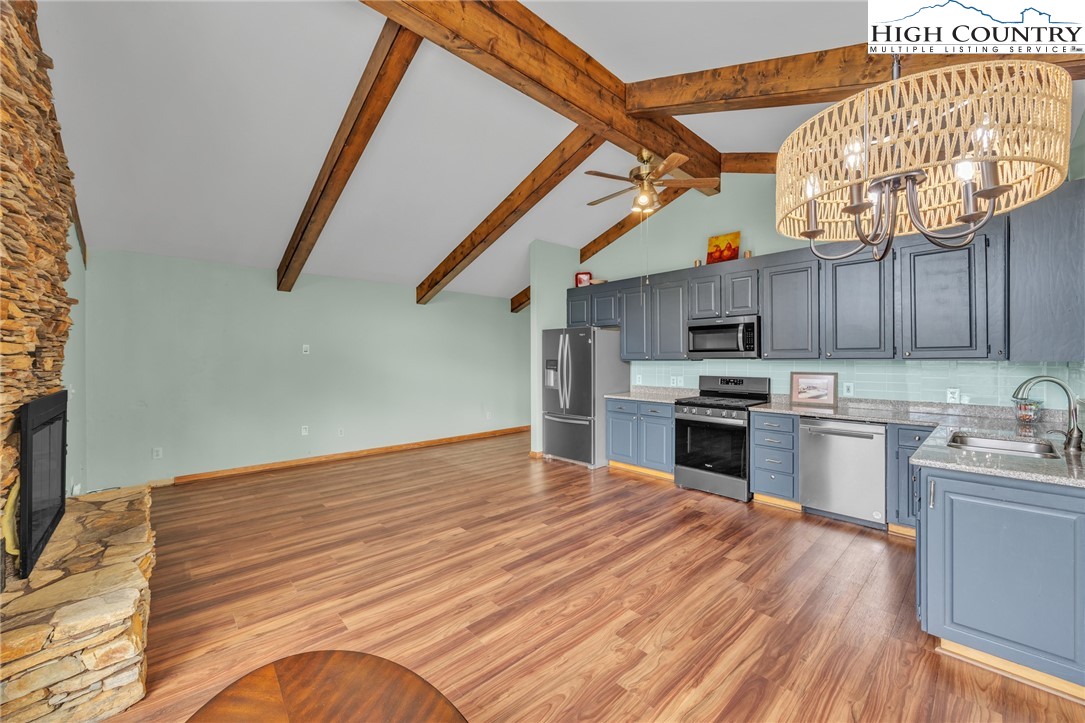 255 Clear View Ridge Crumpler, NC 28617 - Photo 11 of 42 a kitchen with stainless steel appliances granite countertop a sink dishwasher and a stove top oven with wooden floor